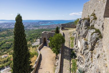 An inside view of the Klis fortress with Split in the background