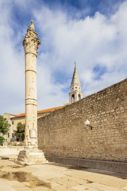 The Roman forum of Zadar with its shame pillar and the tower of the Cathedral in the background