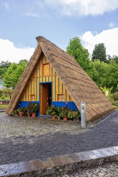 stock image Blue and yellow Santana style house with high thatch roofs