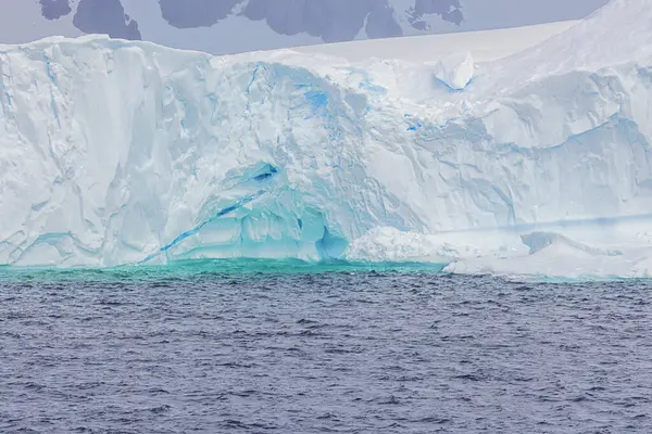 stock image Intense colors from the blue ice in the core of an iceberg between Lemaire and Bryde Island