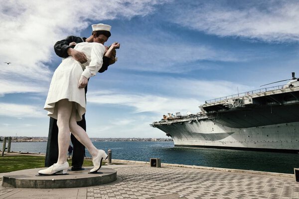 Capture the spirit of romance and historic nostalgia with this captivating photograph of San Diegos famous Unconditional Surrender statue. Depicting a sailor and a woman locked in a passionate kiss