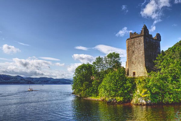 Stand on the precipice of history with this striking photograph of Urquhart Castle main tower, majestically overlooking the enigmatic waters of Loch Ness. As one of Scotlands largest castles, it