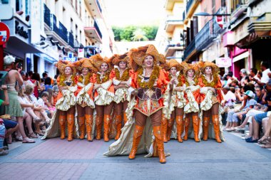 Denia, Alicante, Spain, 15 August 2013. Girls in carnival costumes at a street procession. The annual Moors and Christians festival.