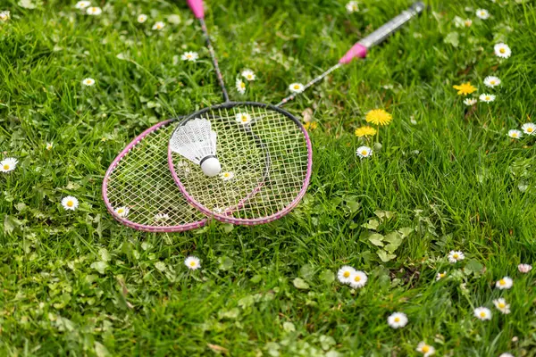 Two Badminton Rackets Shuttlecock Lie Green Grass Outdoor Recreation Fresh — Stock Photo, Image