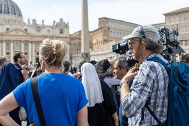 Vatikan - 23 Nisan 2025: St. Peters Meydanı 'ndaki hacıları çeken kameraman.