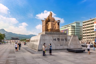 Seoul, South Korea, July 2, 2023: The statue of King Sejong stands prominently at Gwanghwamun Square under a clear blue sky. This landmark honors the creator of Hangul, the Korean alphabet. clipart