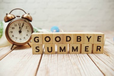 Goodbye Summer alphabet letter and alarm lock decoration on wooden background