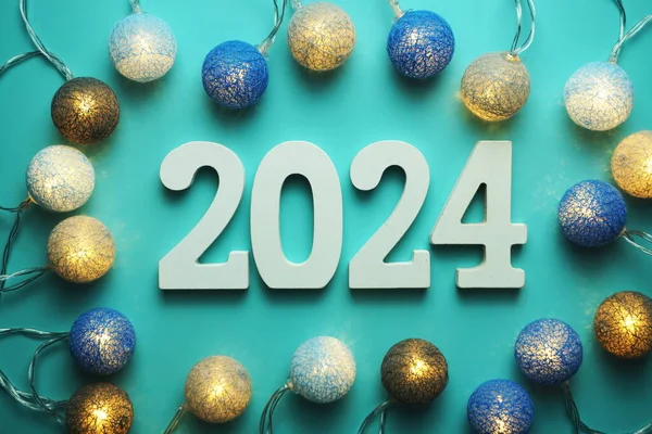 stock image Happy New Year 2024 alphabet letter with cotton ball LED decoration on blue background