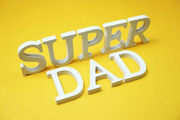 Super Dad alphabet letters on yellow background