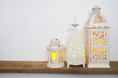 White lantern with LED candle light Home decoration accessories on wooden shelves