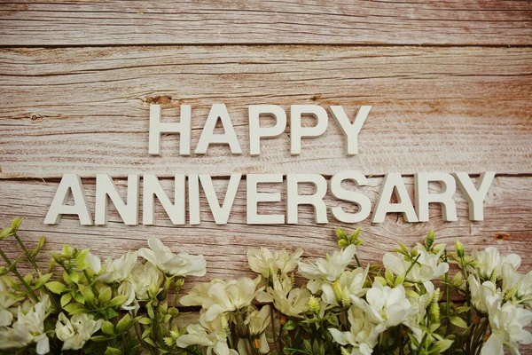 Happy Anniversary Alphabet Letters Flowers Frame Wooden Background — Stock Photo, Image