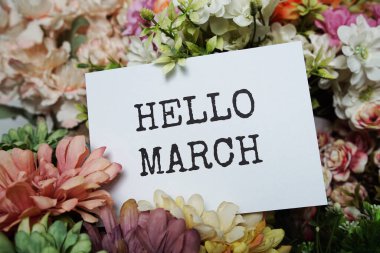 Hello March text message on paper card with beautiful flowers decoration clipart
