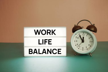 Work Life Balance text message on paper card with wooden easel and alarm clock clipart