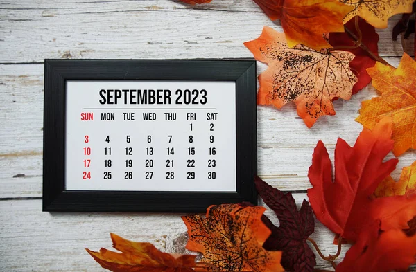 stock image September 2023 monthly calendar with maple leaf on wooden background