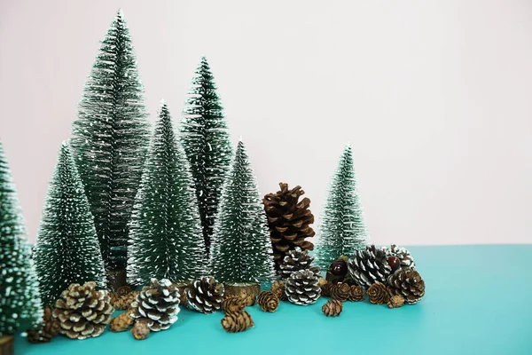 stock image Chritsmas and happy new year holidays background with Christmas trees and pine cone on pink and blue background