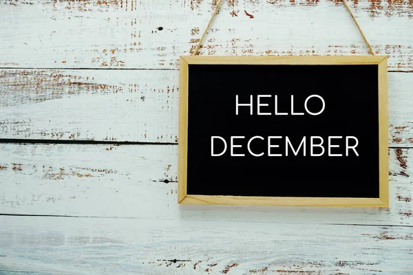 Hello December Typography Text Blackboard Hanging Wall Background — стоковое фото
