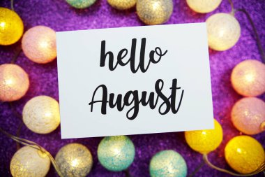 Merhaba August text on paper card top view on mor bokeh background