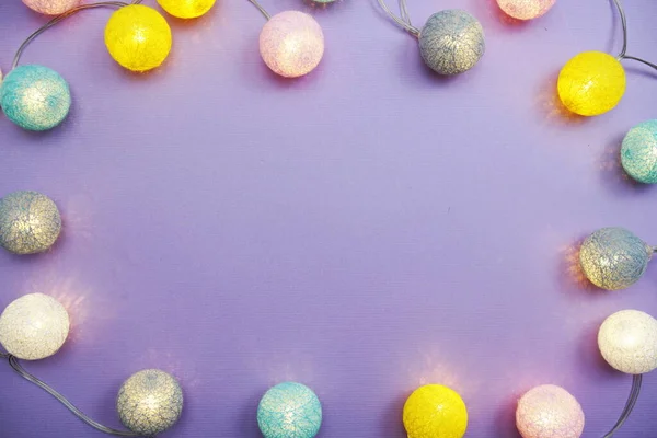 LED cotton ball garland decorate on purple background