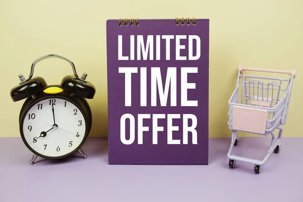Limited Time Offer text message with alarm clcok and trolley shopping cart on yellow background, Business concept background