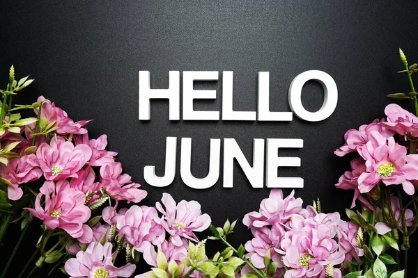 Hello June alphabet letter with flower decoration on black background