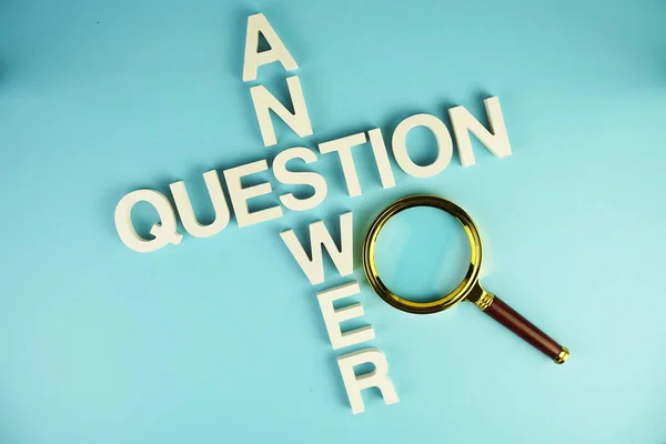 Question and Answer alphabet letters with magnifying glass on blue background