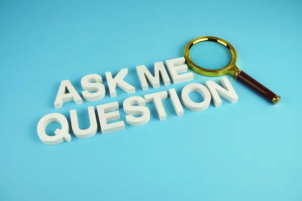 Ask me question alphabet letters with magnifying glass on blue background