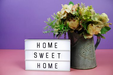 Pembe ve mor arkaplanda LED Işıkkutusu üzerine Home Sweet Home antetli metin