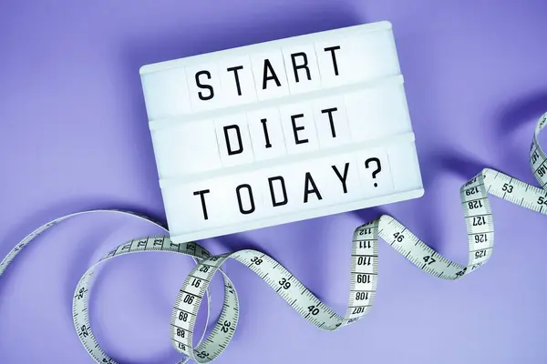 stock image Start diet today? letterboard text on LED Lightbox and Measuring tape on purple background, Healthcare concept