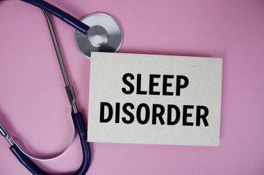 Pembe arka planda steteskoplu Uyku Bozukluğu metni, sağlıklı ve sağlıklı olma kavramı