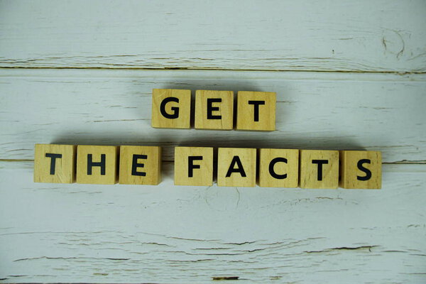 Get The Facts with wooden blocks alphabet letters on wooden background