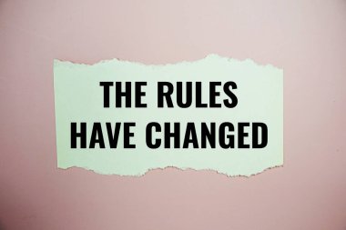 The Rules Have Changed text written on paper torn top view on pink background clipart