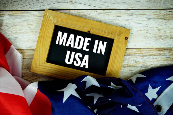 Made in USA text message with USA flag on wooden background