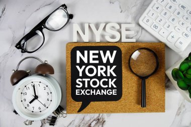 NYSE - New York Stock Exchange acronym with calculator, alarm clock and magnifying glass, Business concept background clipart