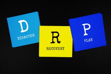 DRP - Disaster Recovery Plan acronym text on sticky note on black background clipart