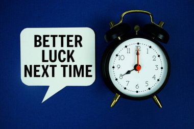 Better Luck Next Time text on speech bubble with alarm clock top view on blue background clipart