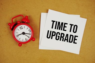 Kağıt zanaat arka planında alarm saatiyle yapışkan nottaki metni güncelleme zamanı