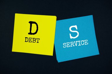 Debt Service (DS) text message on stick note on black background clipart