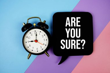 Are You Sure? text on speech bubble with alarm clock top view on blue, purple and pink geometric background clipart