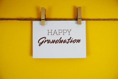 Sarı arkaplanda kağıt üzerinde Mutlu Mezuniyet metinleri