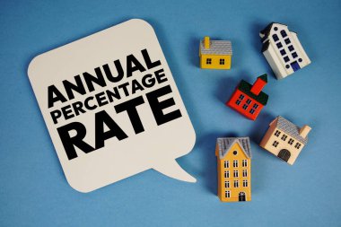 APR Annual Percentage Rate text with house models on blue background