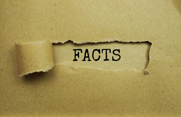 Facts message written on craft paper with torn paper background