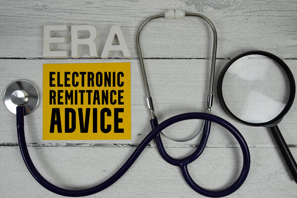 ERA Electronic Remittance Advice text with Stethoscope on wooden background
