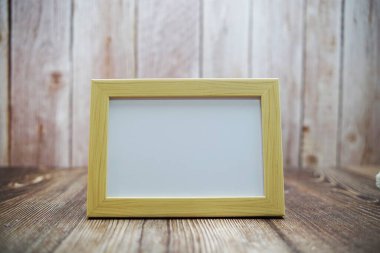 Ahşap zemin üzerinde boş fotoğraf çerçevesi mocup