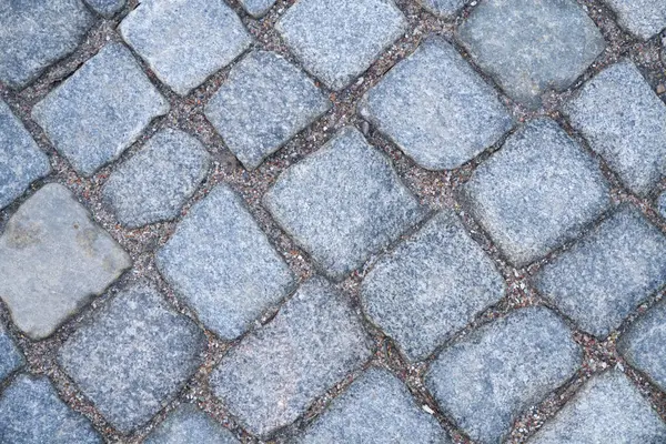 a blue stone floor with a small square pattern