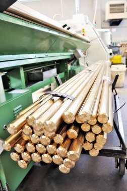 Cart with Brass Bars near CNC Lathe machine