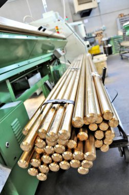 Cart with Brass Bars near CNC Lathe machine