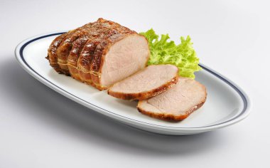 Oval dish with roast meat and salad Isolated on white background