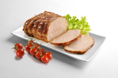 Rectangular white plate with roasted meat salad and tomatoes isolated on white background