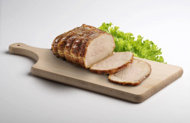 Wooden cutting board with roasted sliced meat isolated on white background