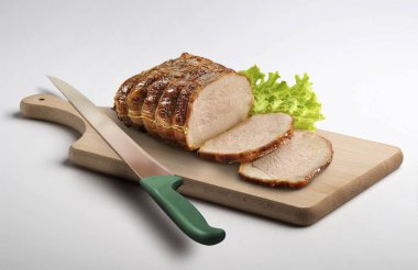 Wooden cutting board with roasted sliced meat isolated on white background